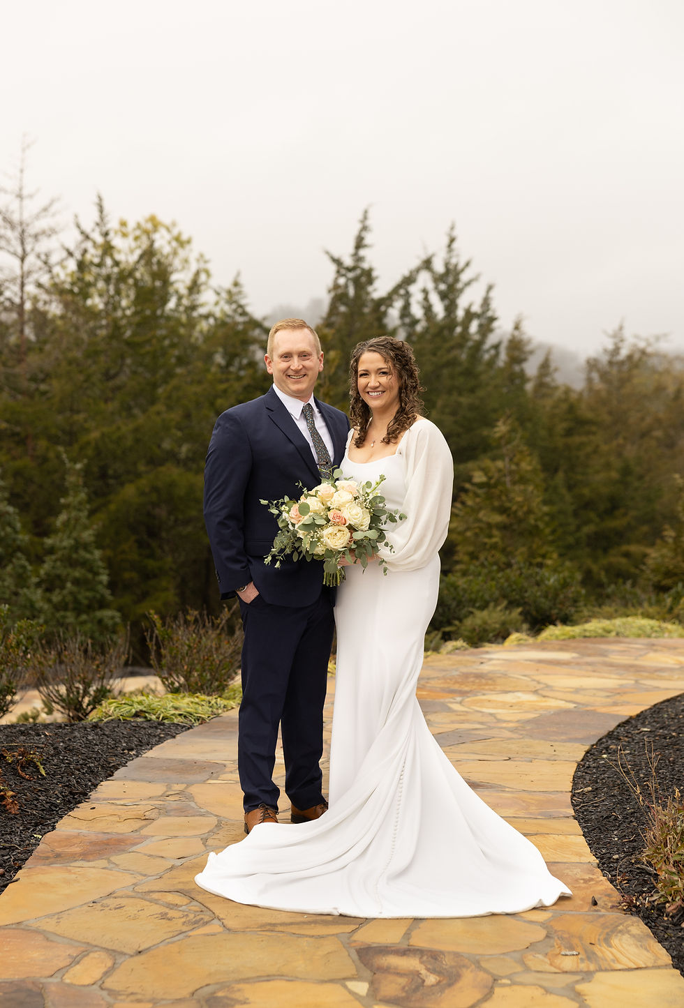 Traditional full boy portrait of the bride and groom smiling.