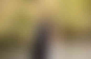 bride and groom smiling as bride holds groom from behind