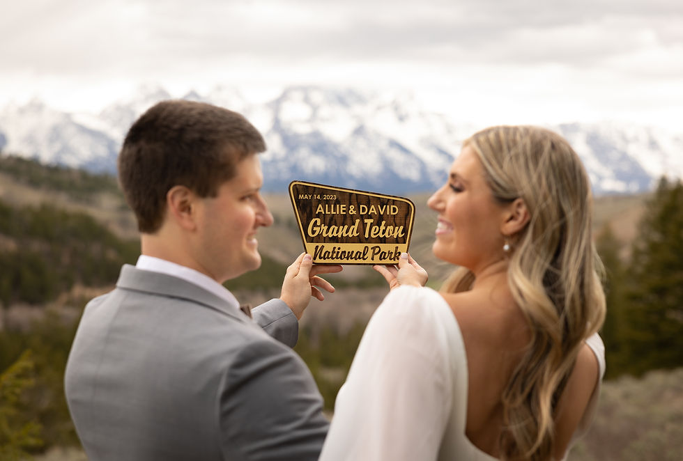 newlyweds showing off their wedding sign