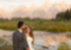bride and groom holding hands and walking by the river 