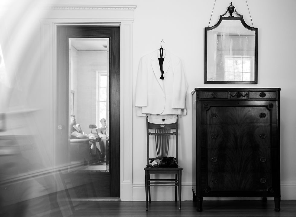 The groom's suit hanging on a wall at hill house durham.