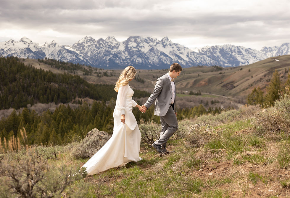 A bride and groom walking while holding hands at The Wedding Tree near Jackson Hole.