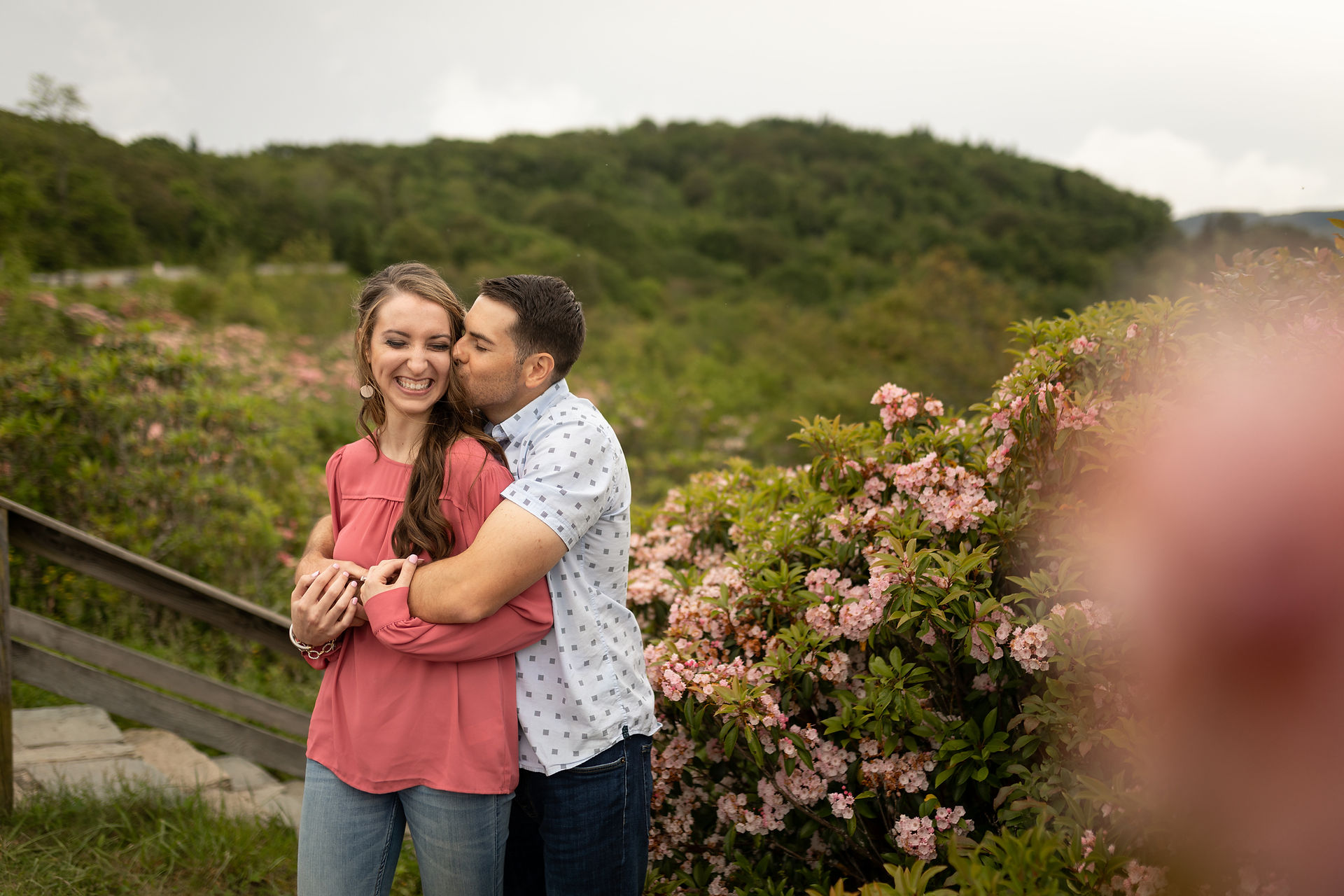 man kissing his fiance on the cheek 