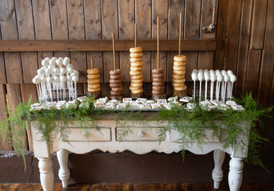doughnuts and cake pops dessert table