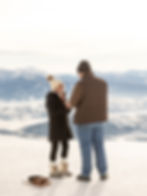 A woman is still in shock moments after her boyfriend proposes. She smiles at him while trying to catch her breath.