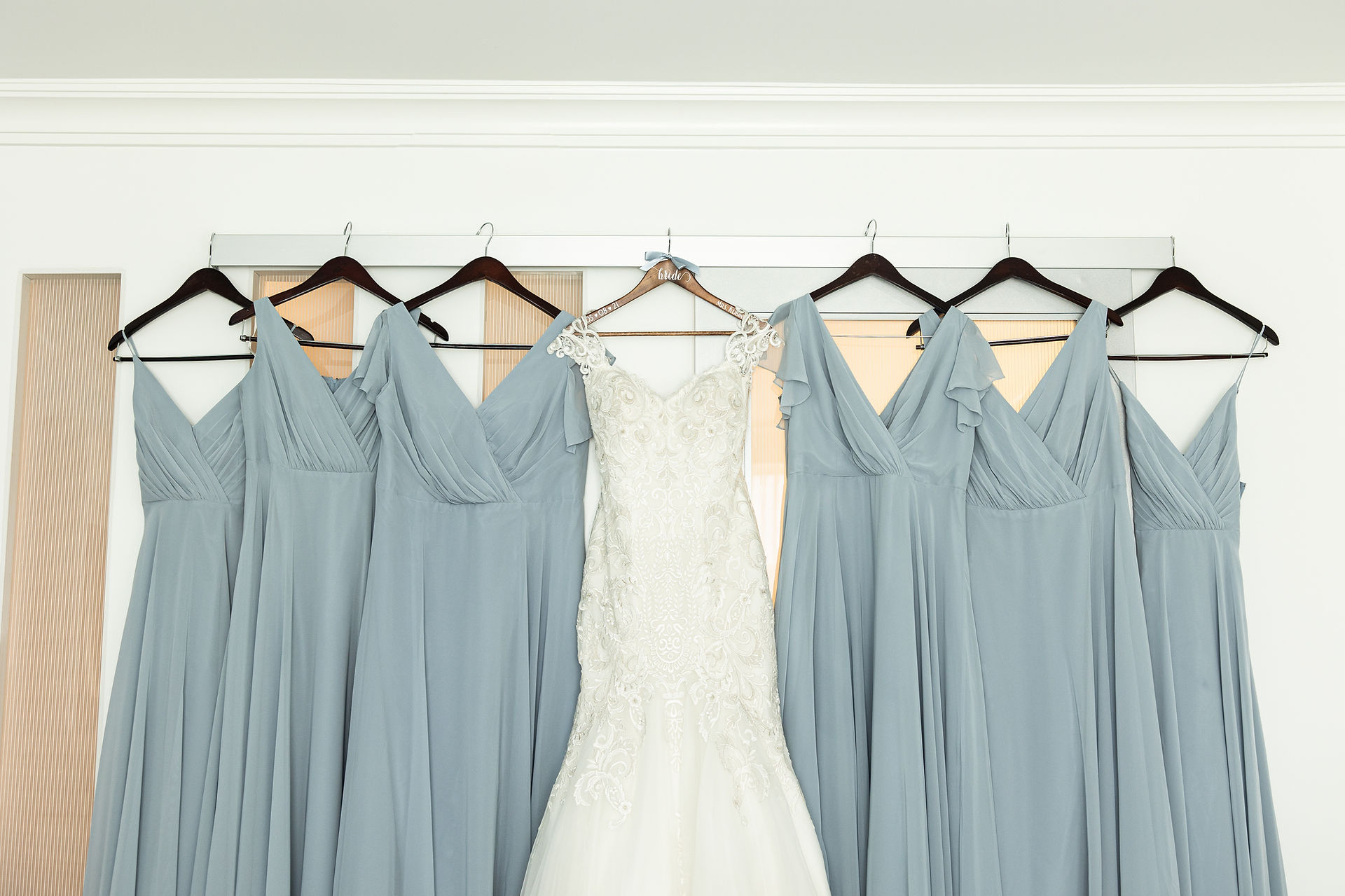 bride and bridesmaids dresses hanging up 
