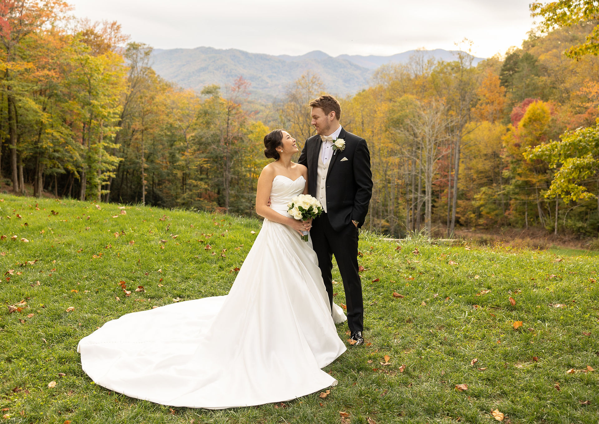 bride and groom smiling at each other 