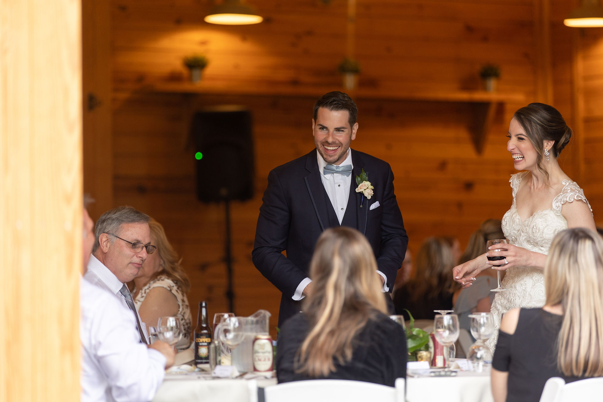 groom talking to guests and laughing 
