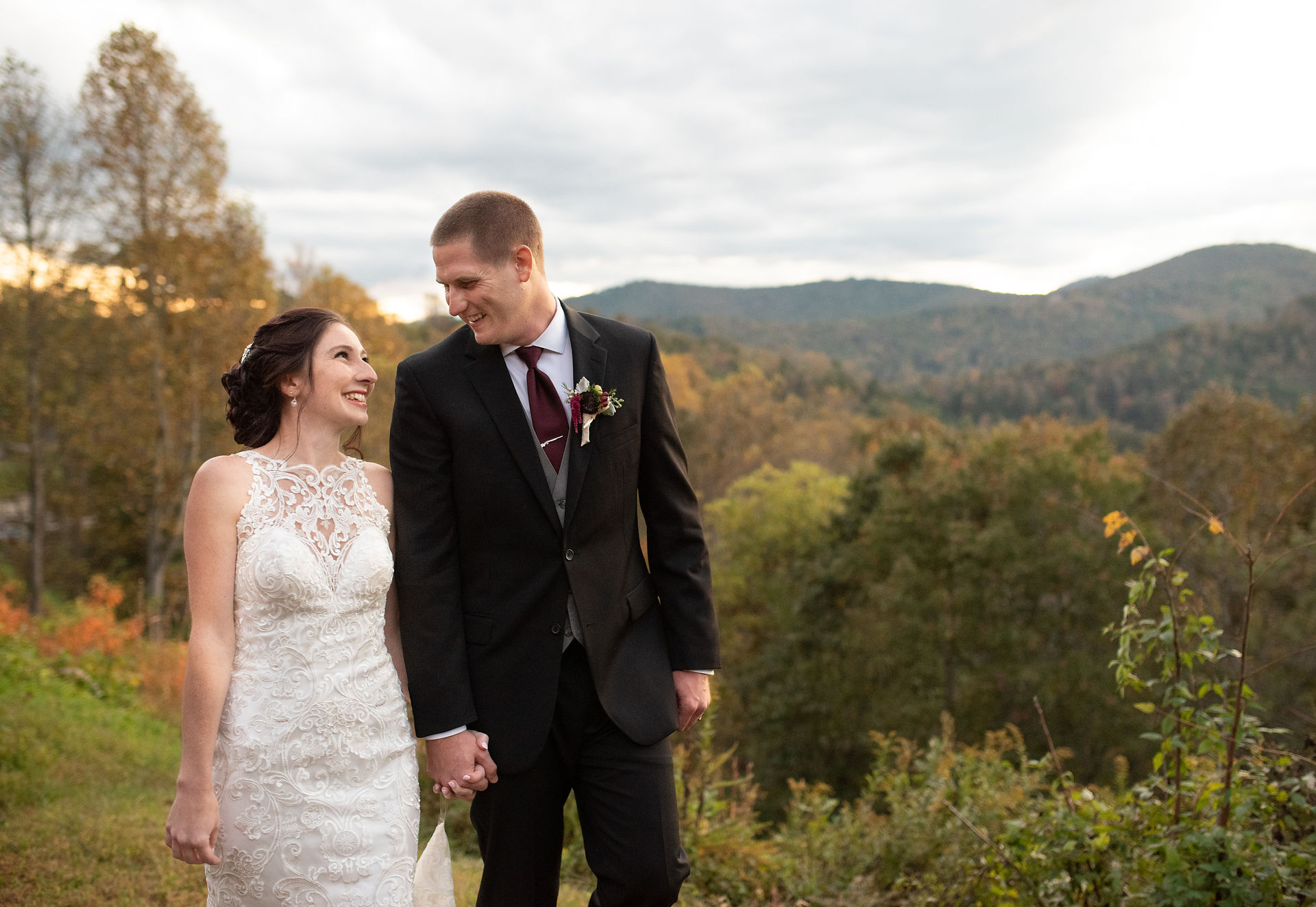 bride and groom holding hands and laughing 
