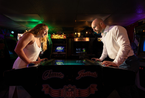 A couple playing air hockey.