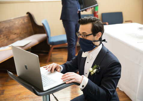 groom setting up zoom for his ceremony