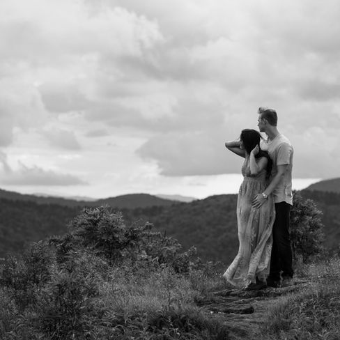 engaged couple holding each other and looking at the view