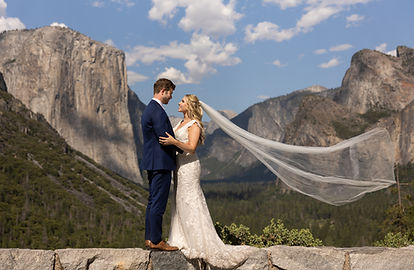 Bridge and Groom standing Holding Each Other with the Mountains in background