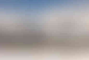 environmental portrait of a couple holding each other in front of the grand tetons