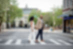 engaged couple crossing the street in asheville