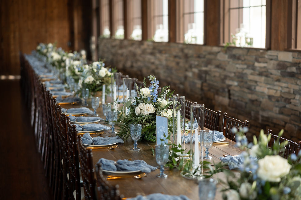 Farm style wedding tables with blue and white florals and decor.