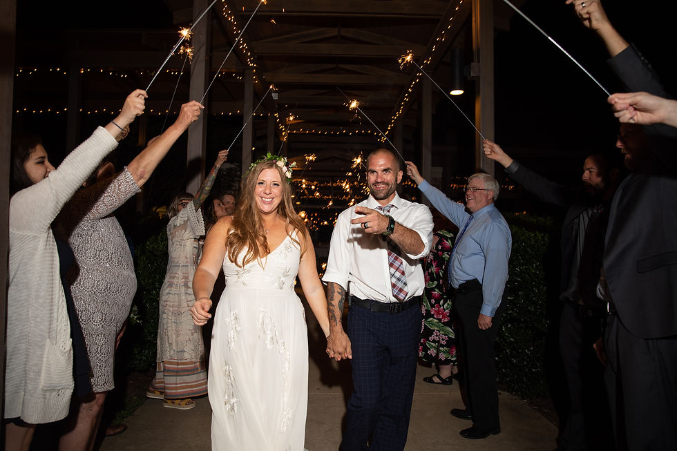bride and groom smiling during their sparkler exit