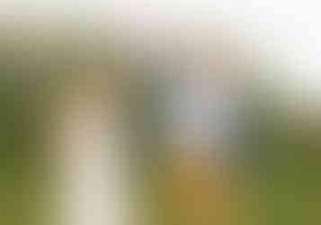 bride and groom holding hands and laughing