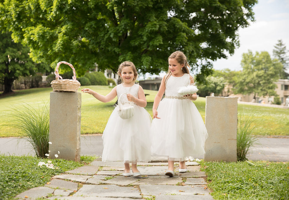 the flower girls walks down the aisle