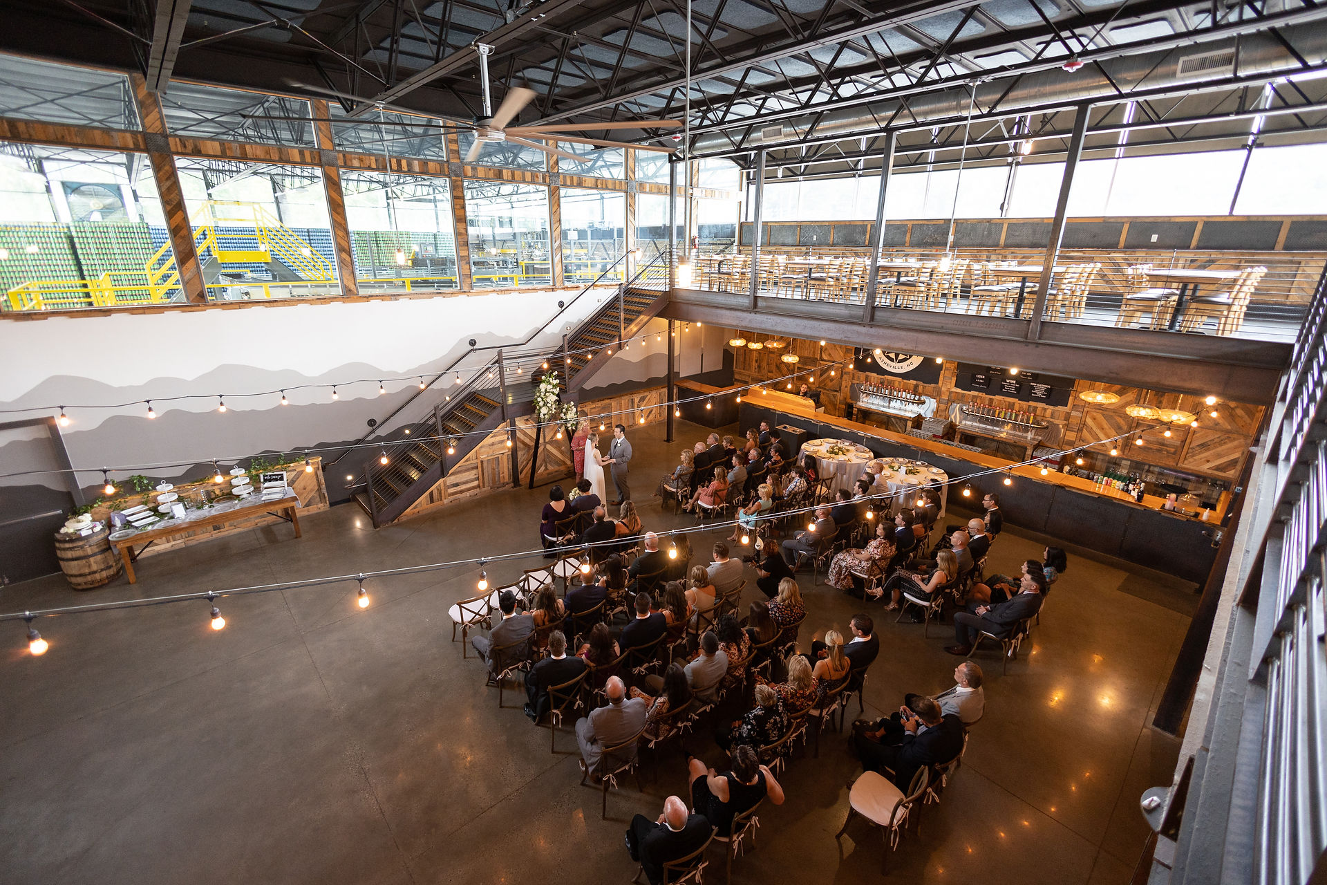 shot of wedding ceremony indoors at highland brewing co 