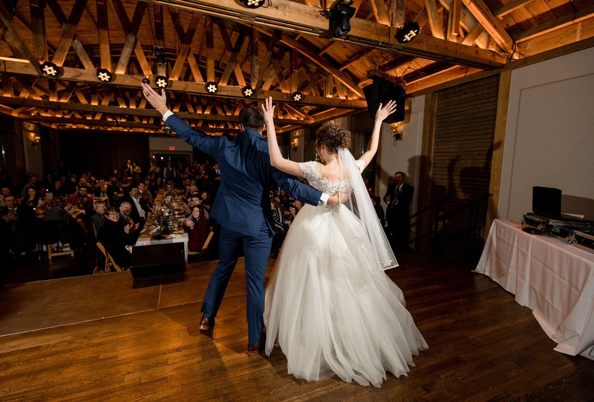 bride and groom waiving to their guests 