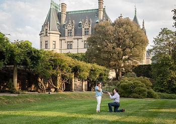 man proposing to his fiance in front of the biltmore