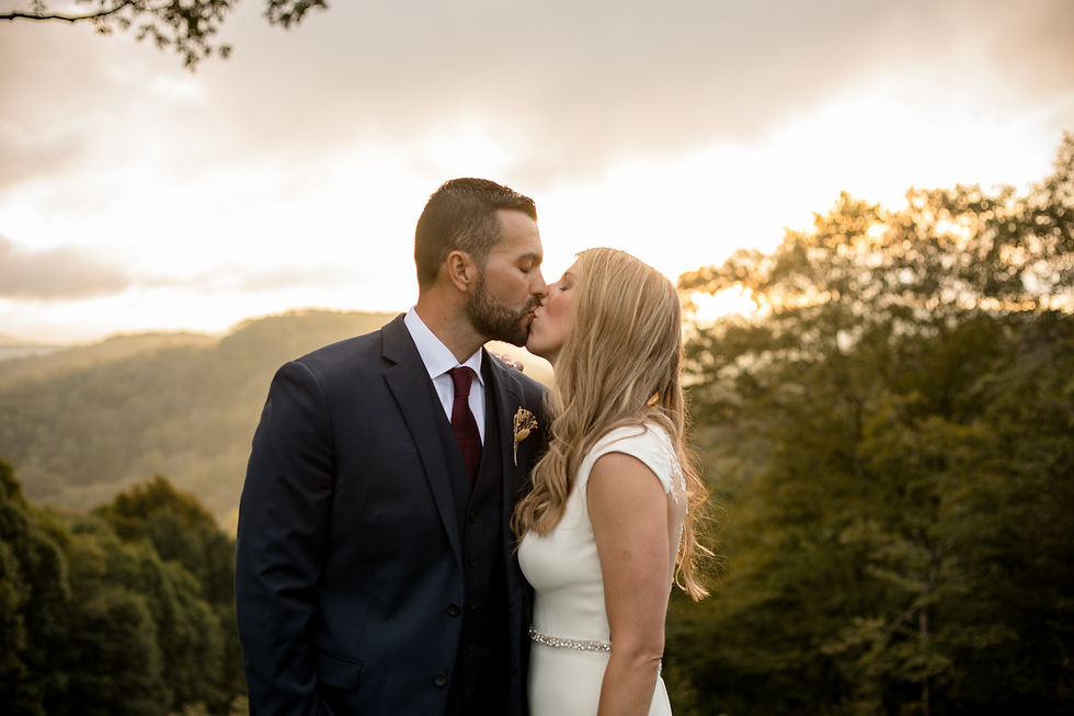 bride and groom kissing during golden hour