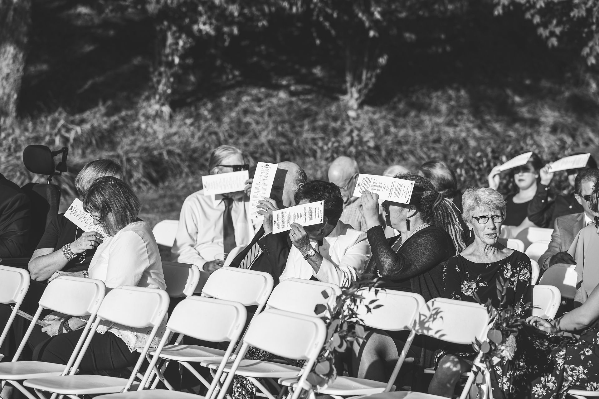 wedding guests covering up their faces 