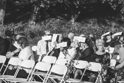 wedding guests covering up their faces