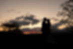 silhouette of the bride and groom kissing during sunset