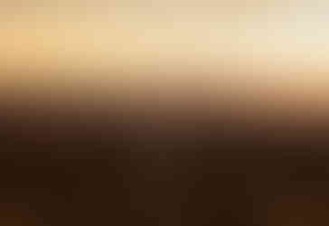 Sunset portrait of a couple smiling in the mountains.