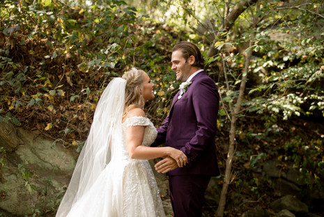 bride and groom holding hands and smiling