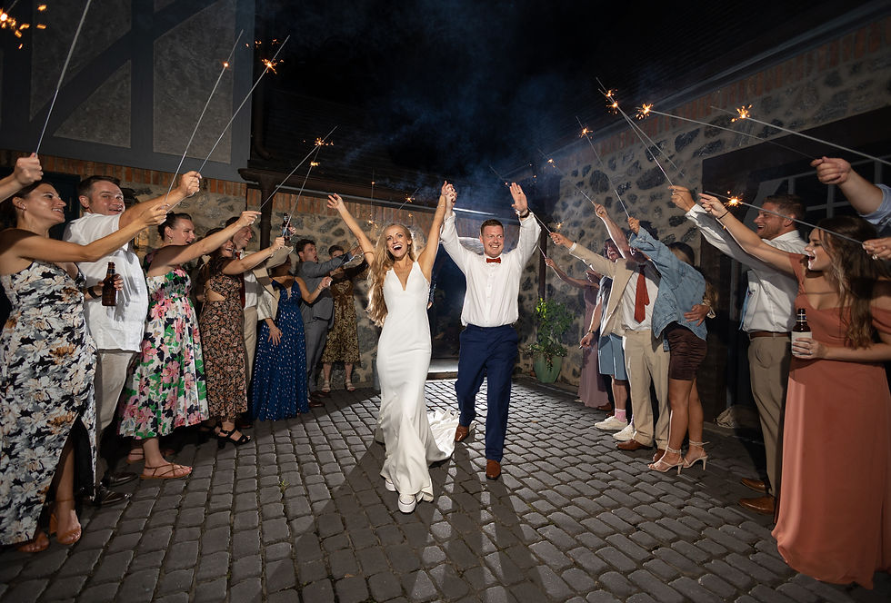 the bride and groom celebrating during their wedding exit