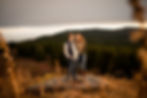couple smiling at each other in the mountains