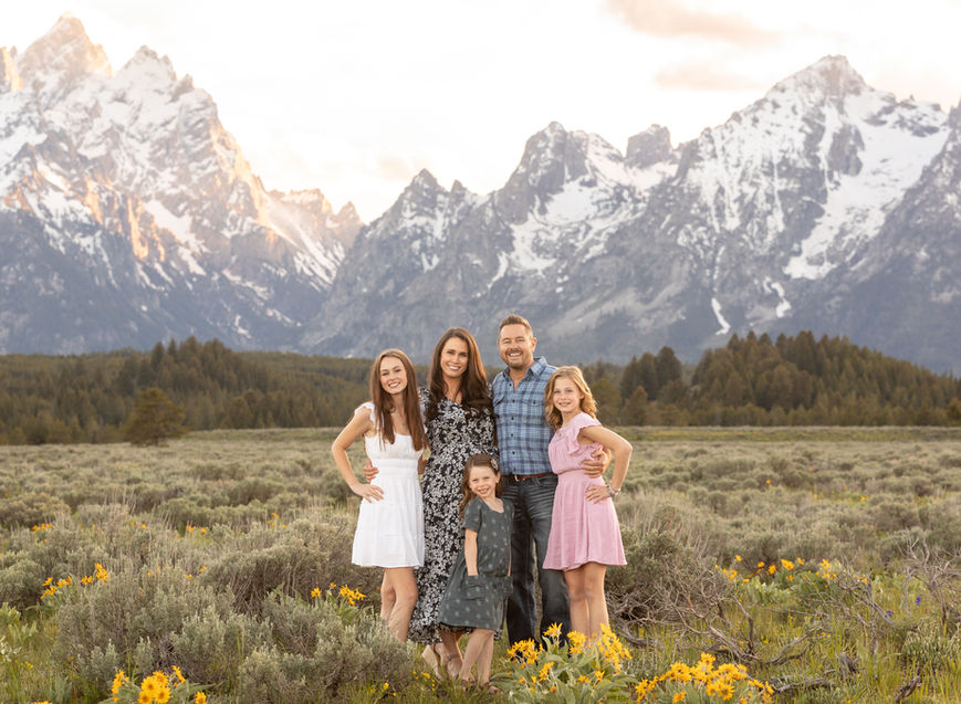 Beautiful sunset portrait of a family in front of the Grand Tetons
