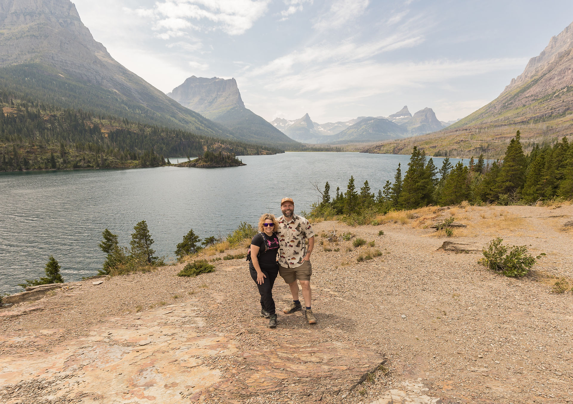 couple taking a photo in front of the water 