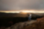 dramatic lighting portrait of a couple holding each other in front of the mountains