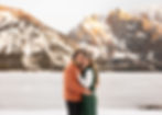 traditional portrait of an engaged couple smiling in front of the grand tetons