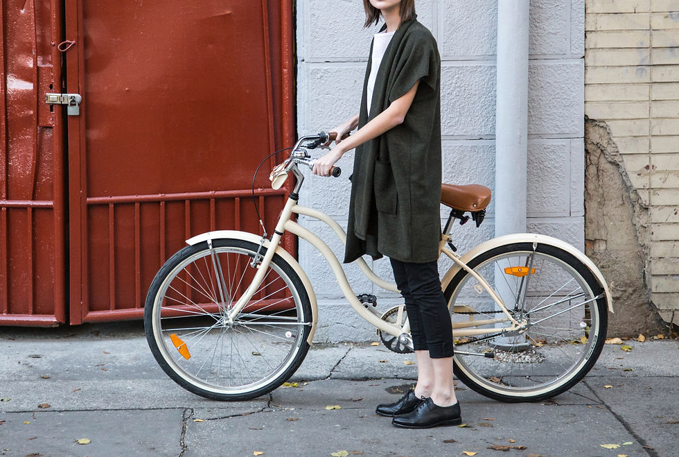 High angle view of a stylish outfit laid out on a bed with accessories