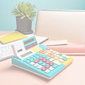 vintage calculator on clean white desk bright colors.jpg