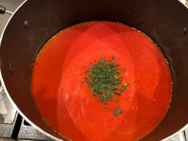 Add basil and let simmer