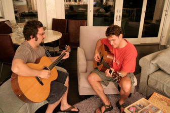 Alex Wolf giving guitar lessons to Brent.