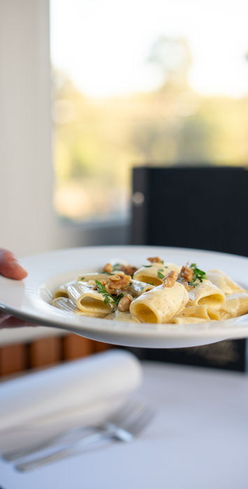 Italian pasta dish being served at a restaurant in East Melbourne showcasing authentic cuisine and dining experience near the MCG