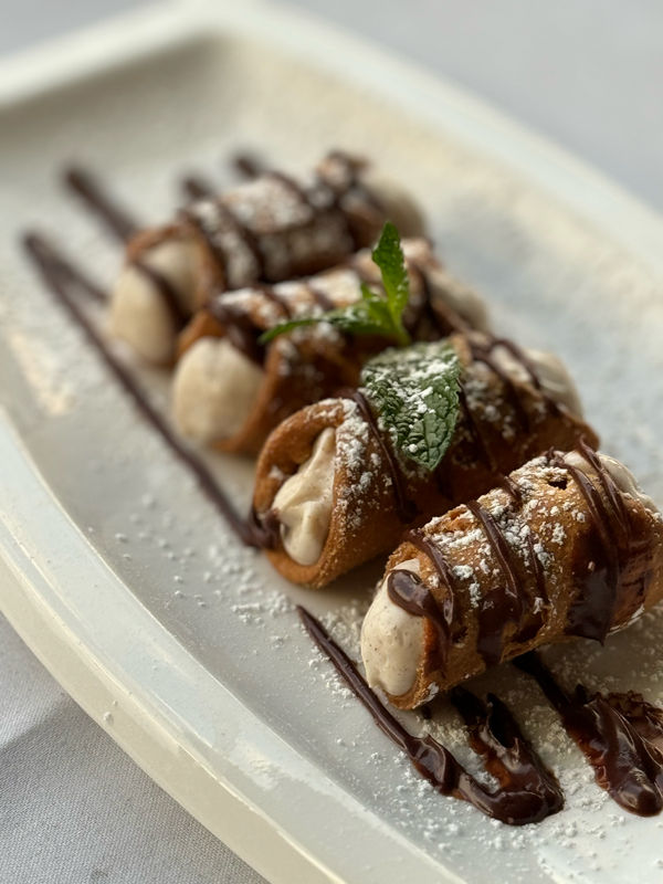 Classic Italian cannoli dessert served in a Melbourne restaurant with ricotta filling and traditional presentation