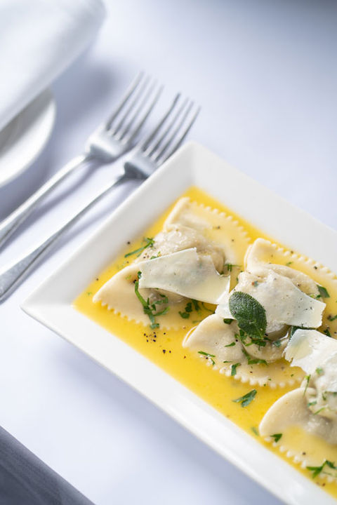 Authentic Italian pasta in Melbourne featuring ravioli with butter sauce and fresh herbs