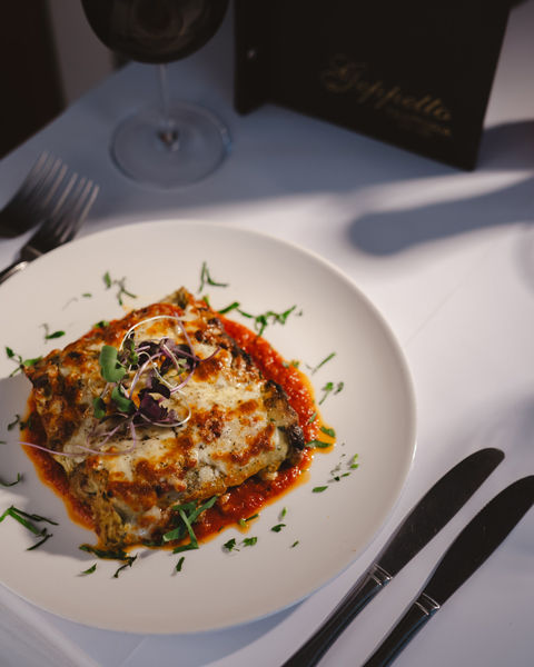 Italian lasagna dish served in Melbourne restaurant with tomato sauce and melted cheese