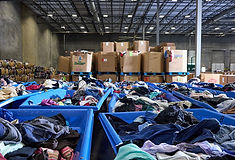 Clothing donations stacked and ready to support Goodwill DFW programs in Texas.