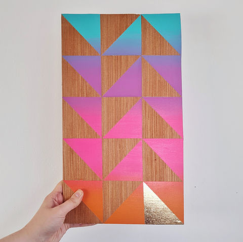 Wooden wall art with geometric design.
