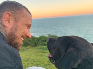 man and his dog are together smiling