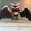 Thumbnail: 3D printed Mothman cryptid figure with red eyes and wide wings, dark ominous collectible decor, 6 inch tall by 11 inch wide